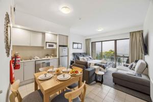 a kitchen and a living room with a table in a room at Lantern 22 - Balcony in Thredbo