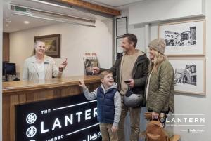 a group of people standing around a counter with a child at Lantern 22 - Balcony in Thredbo