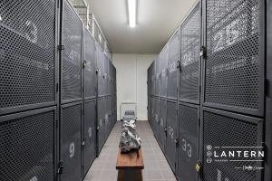 a locker room with black lockers and a bench in it at Lantern 22 - Balcony in Thredbo +15 photos
