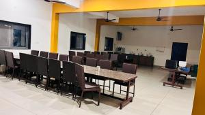 a conference room with a long table and chairs at Chandan resort in Chitrāwal