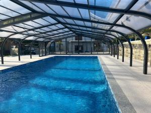 a large swimming pool with a glass roof at Camping du Valentin in Laruns