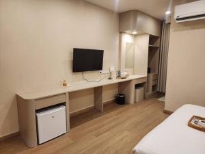 a room with a desk with a television on it at Phusira ภูศิรา กาญจนบุรี in Ban Tha Kilen (1) +27 photos