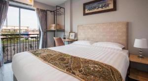 a bedroom with a large bed and a balcony at K Station Pattaya in Pattaya +272 photos