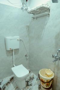 a dirty bathroom with a toilet and a sink at Hotel Ramkrishna Stay in Khajurāho