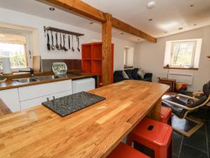 a kitchen with a wooden counter top in a room at Gun Powder Cottage in Tighnabruaich +23 photos