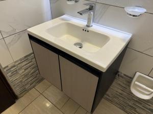 a bathroom with a white sink and a toilet at Sofia Rooms in Palaiochora