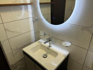 a bathroom with a sink and a mirror at Sofia Rooms in Palaiochora