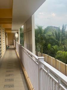 a balcony of a building with a view of trees at Spacious 2BHK Mountain View - Near Palolem Beach in Canacona