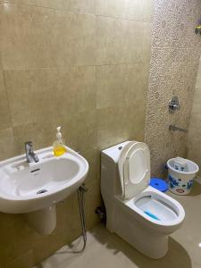 a bathroom with a white toilet and a sink at Spacious 2BHK Mountain View - Near Palolem Beach in Canacona +19 photos