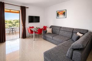a living room with a couch and a table at Vila Bilali in Ksamil