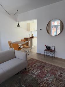 a living room with a couch and a table at TRIPLEX 2 chambres Cosy à MONS in Mons +30 photos