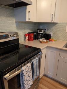 a kitchen with a stove with towels on the oven at Modern, private & luxurious executive suite in Delta