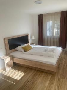 a bedroom with a large bed and a window at Die Perle an der Wutach in Lauchringen