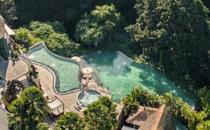 an aerial view of a swimming pool with trees at Aksari Resort & Spa Ubud by Ini Vie Hospitality in Ubud