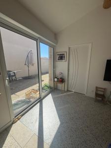 a room with a large sliding glass door with a view at La maison de Petit Pierre in Vauvert