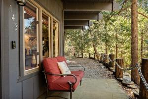 a red chair sitting on the porch of a house at The Arrowhead Pearl in Lake Arrowhead