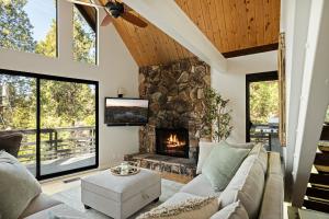 a living room with a couch and a fireplace at The Arrowhead Pearl in Lake Arrowhead