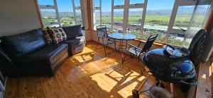 a living room with a couch and a table and chairs at Mountain View in Klein-Brakrivier