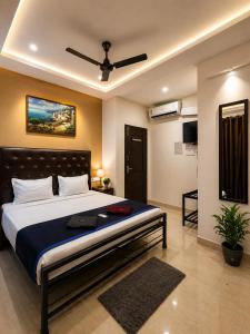 a bedroom with a large bed with a ceiling fan at Hotel bright house in Calangute +74 photos