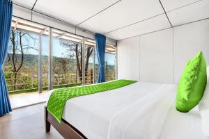 a bedroom with a bed and a large window at Nature Trails Durshet, Khopoli in Khopoli +173 photos
