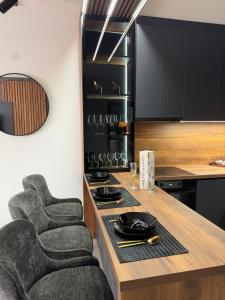 a kitchen with a table with a chair and a stove at Nanna apartman in Ruma