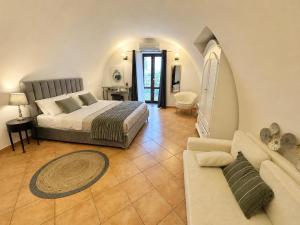 a bedroom with a bed and a couch at Villa Rosmary in Massa Lubrense