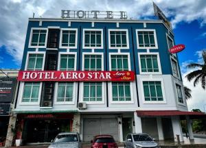 a hotel area with cars parked in front of it at AERO Star Hotel in Seremban