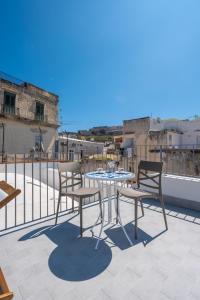 a table and two chairs on a balcony at La casa del Pescatore in Procida