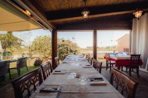 a long table in a restaurant with a view at Agriturismo La Marletta in Imola