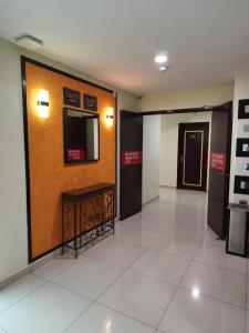 a hallway of a building with a wall with signs on it at AERO Star Hotel in Seremban