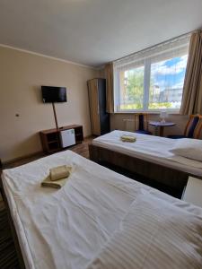 a hotel room with two beds and a window at Centrum Noclegowe II in Bydgoszcz