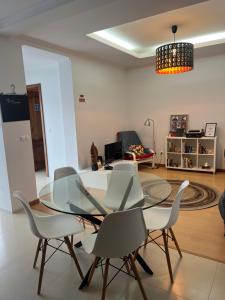 a dining room with a glass table and chairs at Mountain and Sea in Ribeira Grande +32 photos