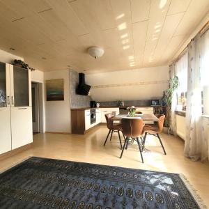 a kitchen and dining room with a table and chairs at Logis Am Park in Dessau