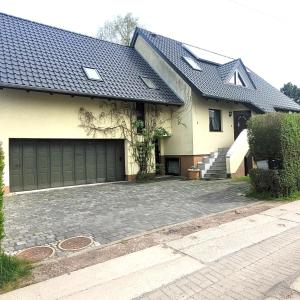a house with a garage and a driveway at Logis Am Park in Dessau