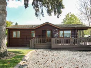a log cabin with a porch and a deck at Foxglove in Leominster