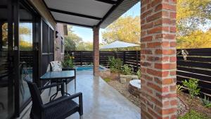 a patio with a table and chairs and a fence at Khaya Kwalata in Marloth Park