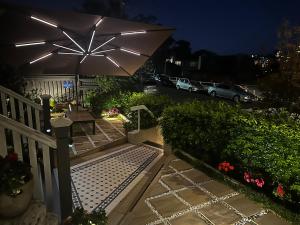 a patio with a table and an umbrella at Cremorne Point Manor in Sydney
