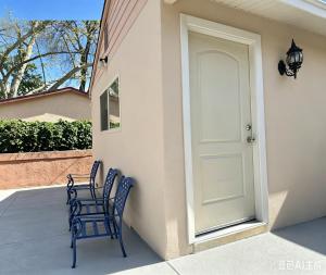 two blue chairs sitting on a porch next to a door at Downtown Private Master Suite in Sacramento