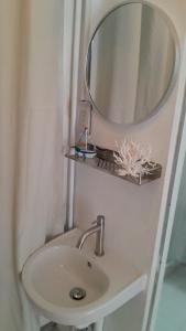 a bathroom with a sink and a mirror on the wall at 365house in Ban Phlu Yai