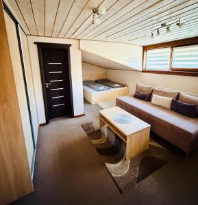 a small living room with a couch and a table at Penzión u Coľa in Prievidza