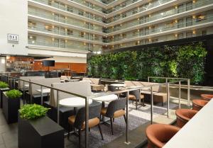 a restaurant with tables and chairs in a building at Embassy Suites by Hilton Chicago Downtown Magnificent Mile in Chicago +44 photos