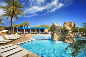 a swimming pool with lounge chairs and a resort at Hilton Phoenix Tapatio Cliffs Resort in Phoenix