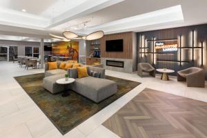 a living room with a couch and a tv at La Quinta by Wyndham Laredo Airport in Laredo