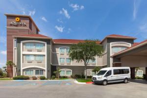 a white van parked in front of a hotel at La Quinta by Wyndham Laredo Airport in Laredo