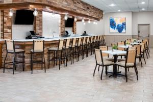 a bar in a restaurant with chairs and tables at Days Hotel by Wyndham Toms River Jersey Shore in Toms River