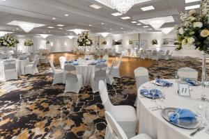 a banquet hall with white tables and white chairs at Days Hotel by Wyndham Toms River Jersey Shore in Toms River +45 photos