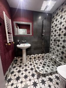 a bathroom with a sink and a mirror at Hotel Kalanga in Tbilisi City