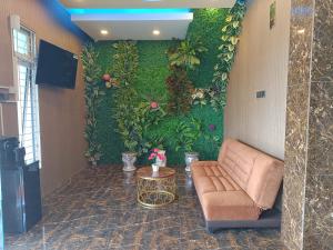 a living room with a couch and a table at Dnaiko Syariah Hotel in Bukittinggi