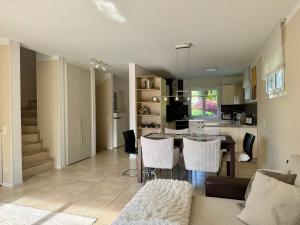 a kitchen and living room with a table and chairs at Casa Sole in Gambarogno