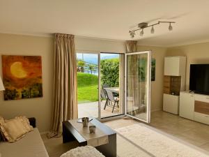 a living room with a view of a patio at Casa Sole in Gambarogno